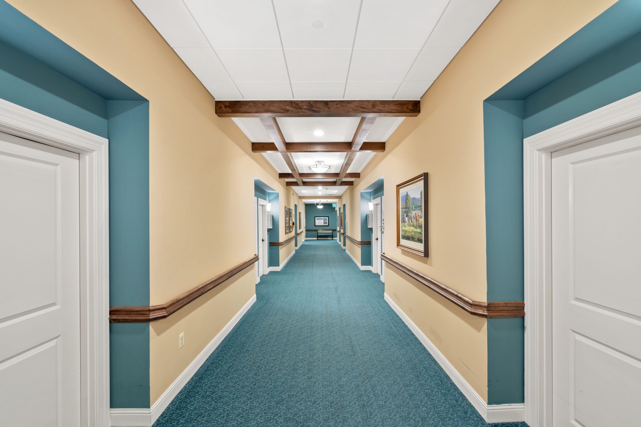 Long blue hallway with wooden beams